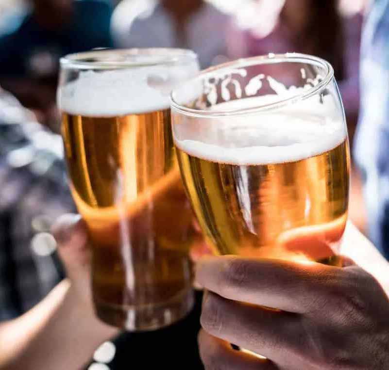 Photo of people drinking pints of beer